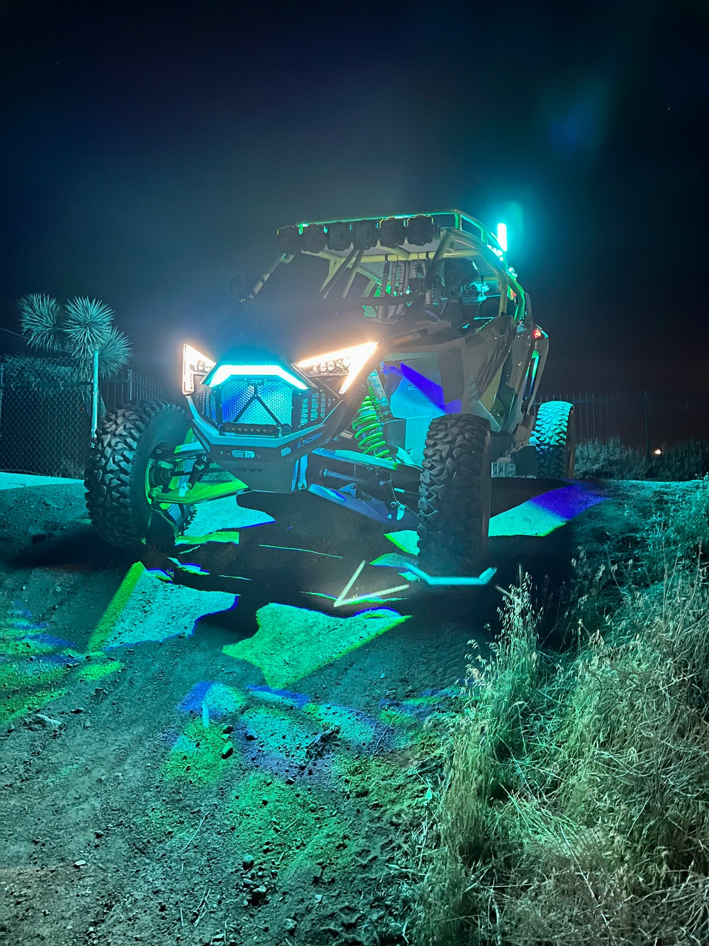 RGB LED Rock Light Kit by My Store, featuring vibrant colors illuminating rugged terrain in a night setting.