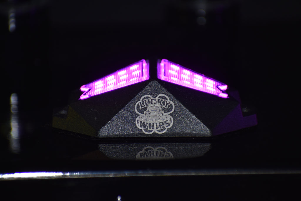 Lucky Whips Chasing Color RGB Rock Lights with four pods, vibrant multicolor LED lighting for automotive or outdoor use.