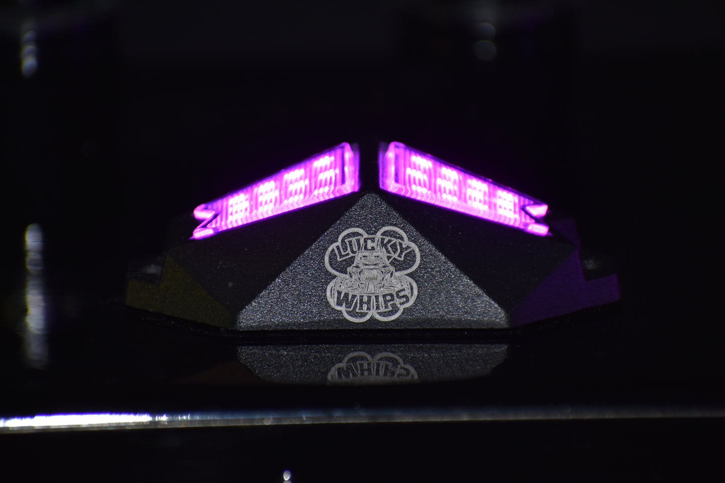 Chasing Color RGB rock lights by Lucky Whips illuminating a rugged terrain with vibrant colors and a sleek design.