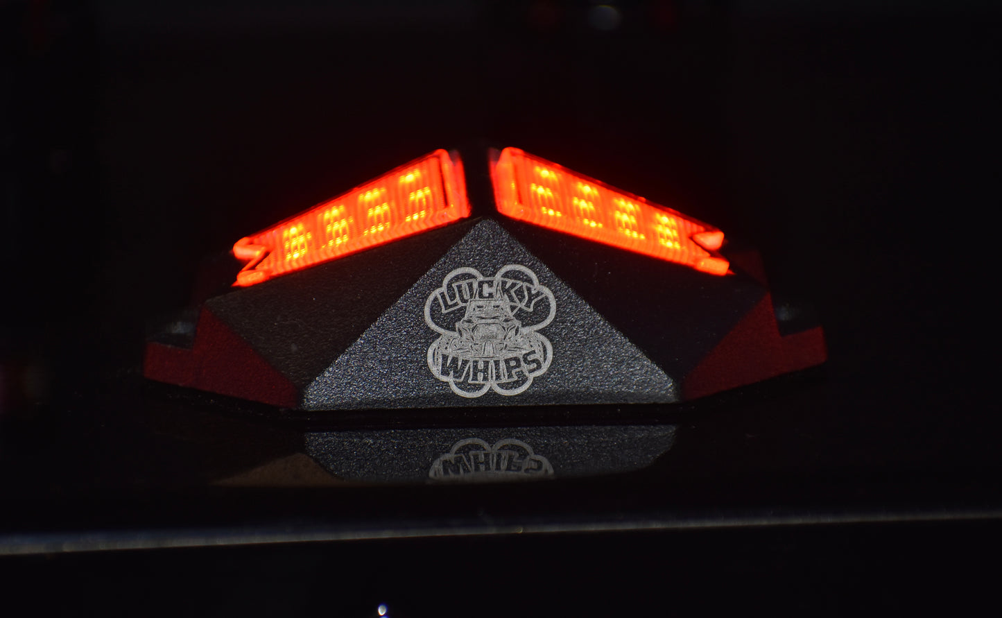 Chasing Color RGB rock lights by Lucky Whips illuminating a dark outdoor setting with vibrant colors.