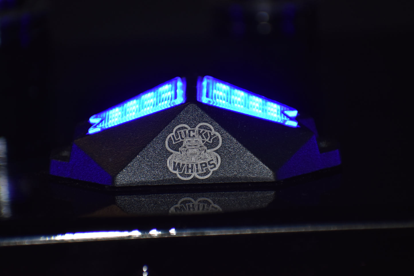 Chasing Color RGB Rock Lights by Lucky Whips illuminating rocks with vibrant colors in an outdoor setting.