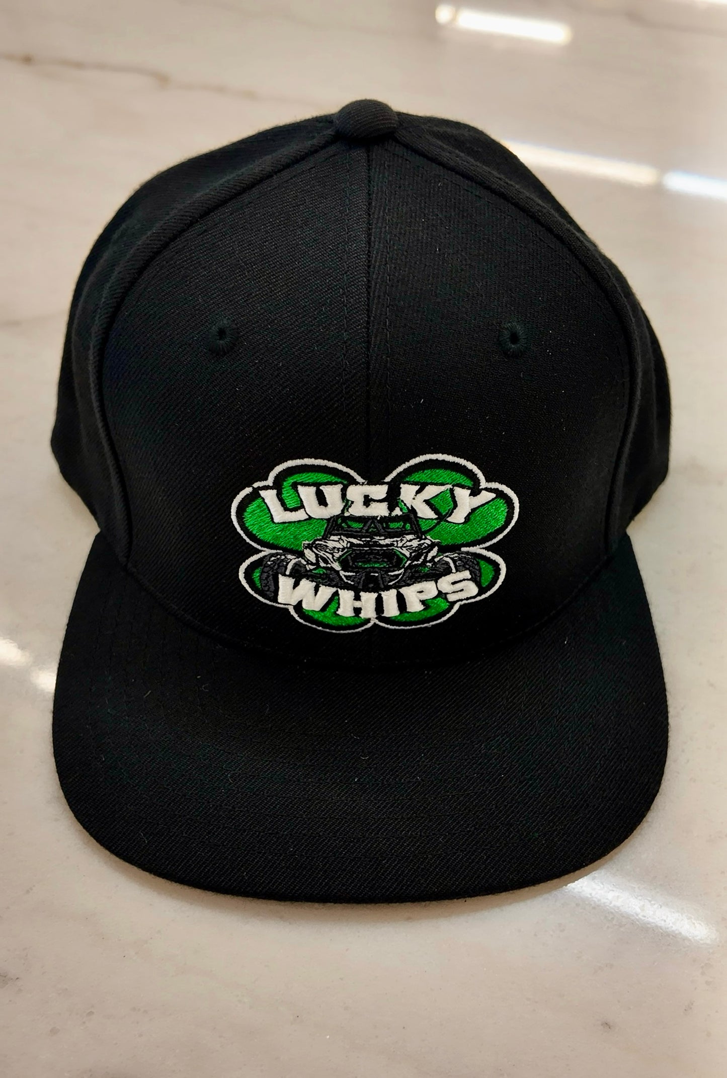 Classic flat bill hat by Lucky Whips featuring a structured design and solid color for a stylish, casual look.