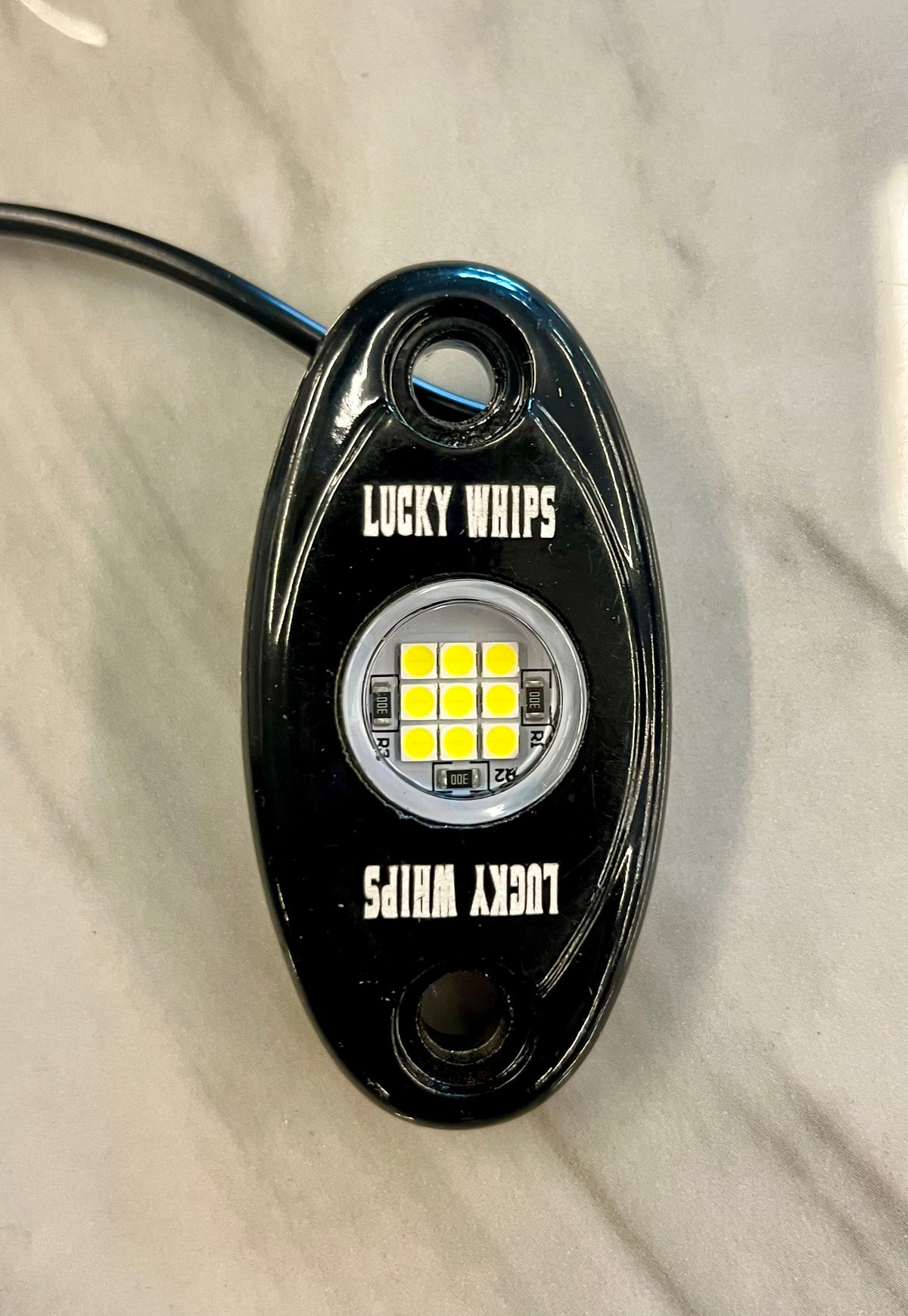 White Lucky Whips Dome Lights showing sleek, modern design with smooth, rounded surfaces ideal for interior lighting.