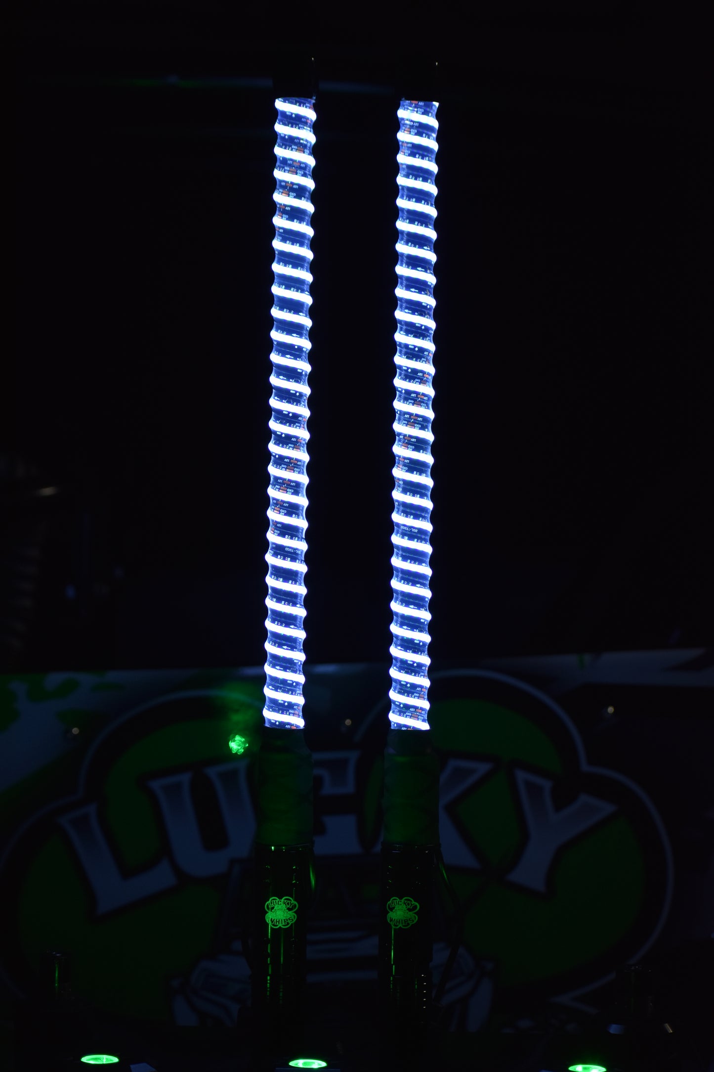 Colorful G1 LED Whips by Lucky Whips illuminated against a dark background, showcasing vibrant light patterns.
