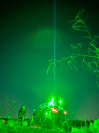 Pair of Lucky Whips Laser Pod Lights showing colorful laser patterns projected onto a surface.