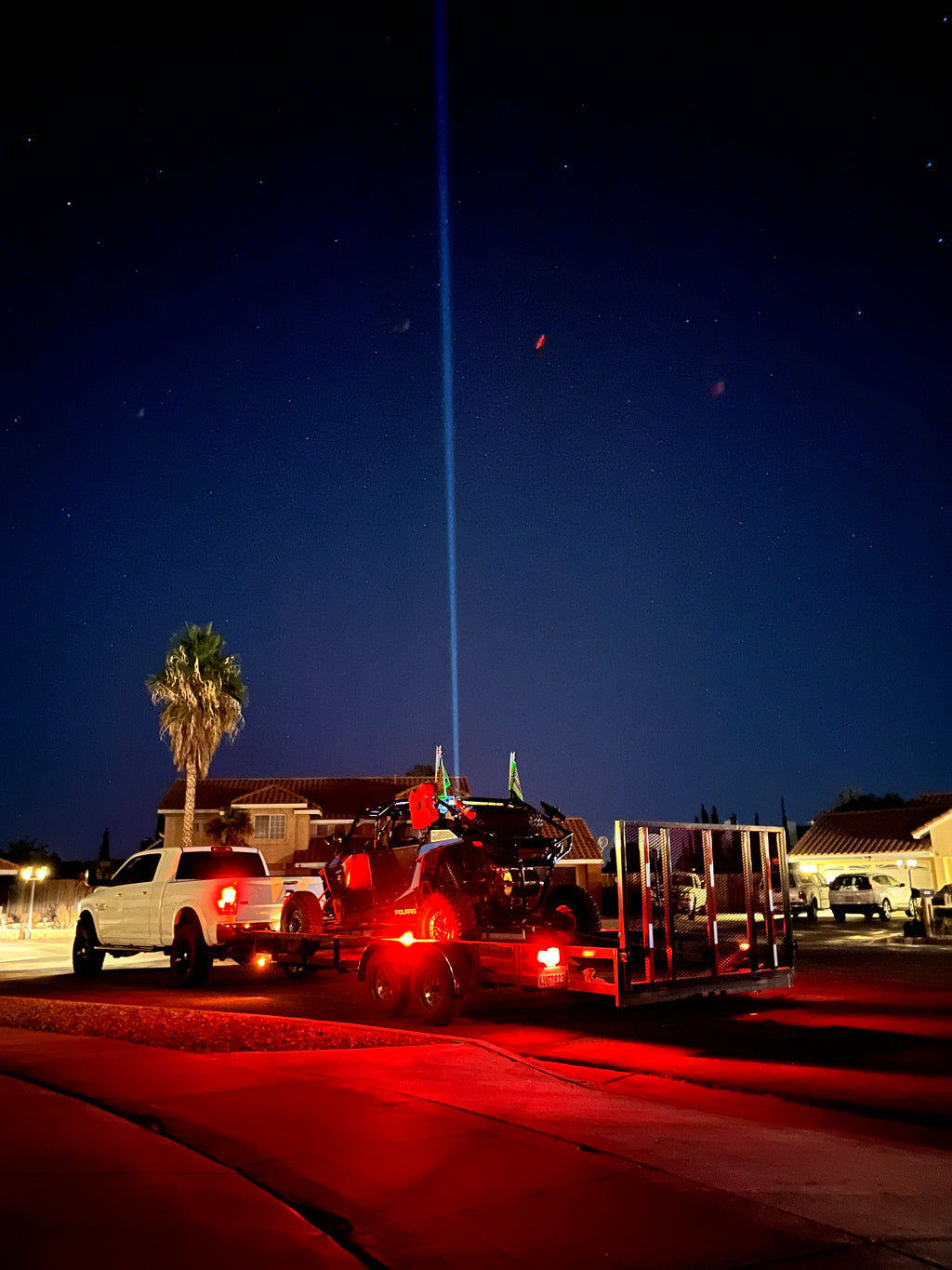 Pair of Lucky Whips Laser Pod Lights showing colorful laser light projections on a surface.