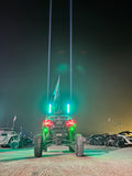 Pair of Lucky Whips Laser Pod Lights with colorful laser beams projecting from compact, sleek lighting devices.