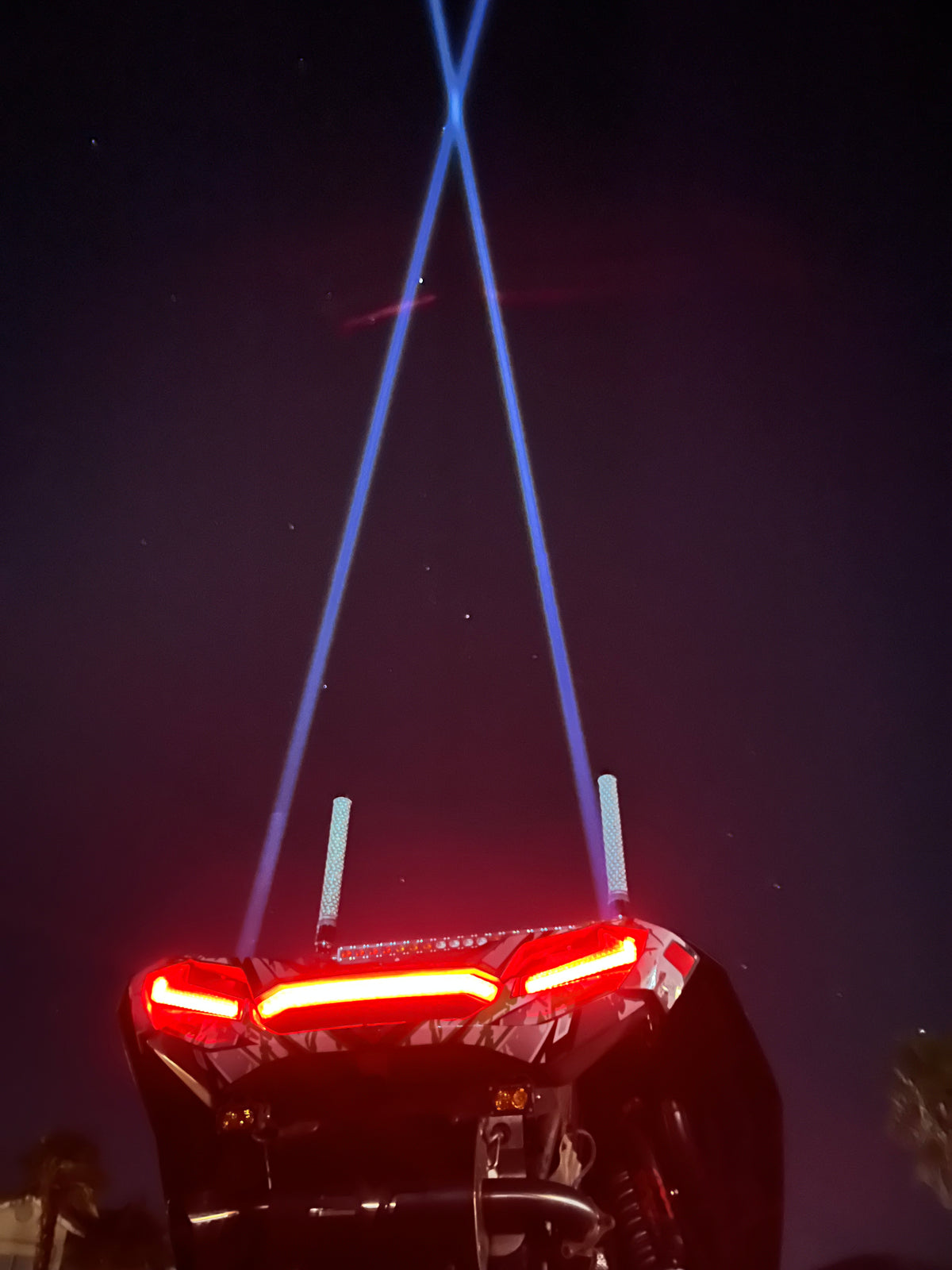Pair of Lucky Whips Laser Pod Lights with colorful laser projections against a dark background.