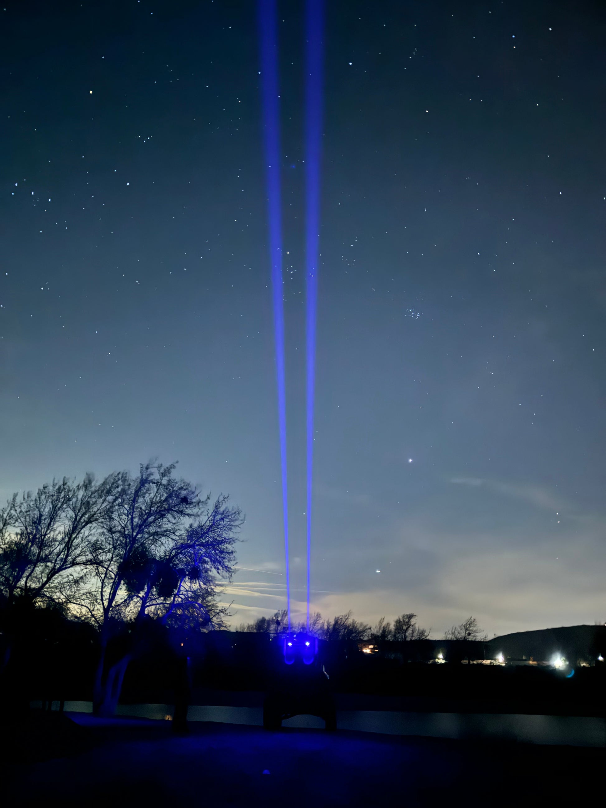 Colorful RGB laser whips from Lucky Whips, showcasing vibrant light patterns and flexible handles in a dark setting.