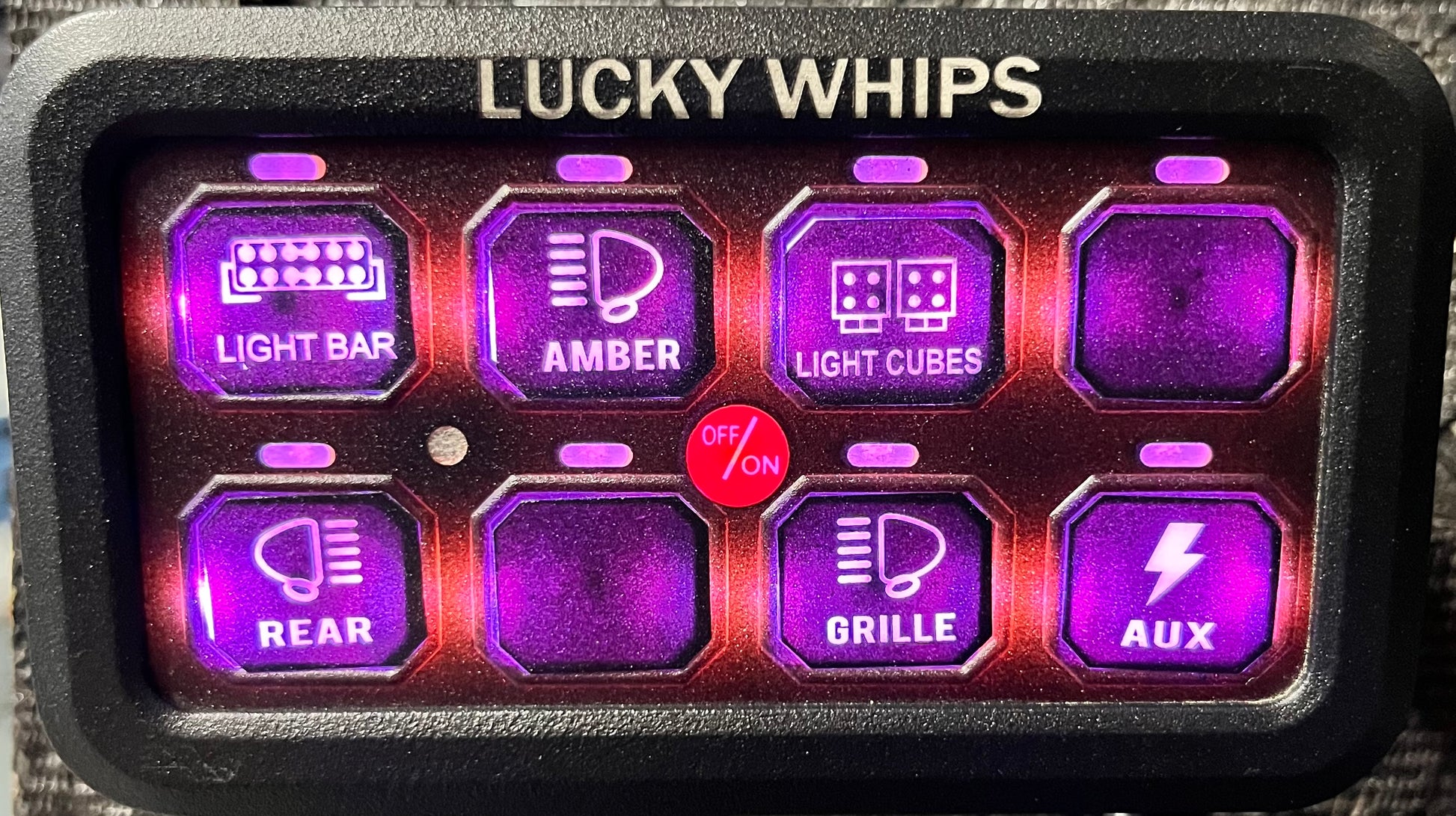 Lucky Whips 8 gang Bluetooth switch panel with illuminated switches and a sleek black design.