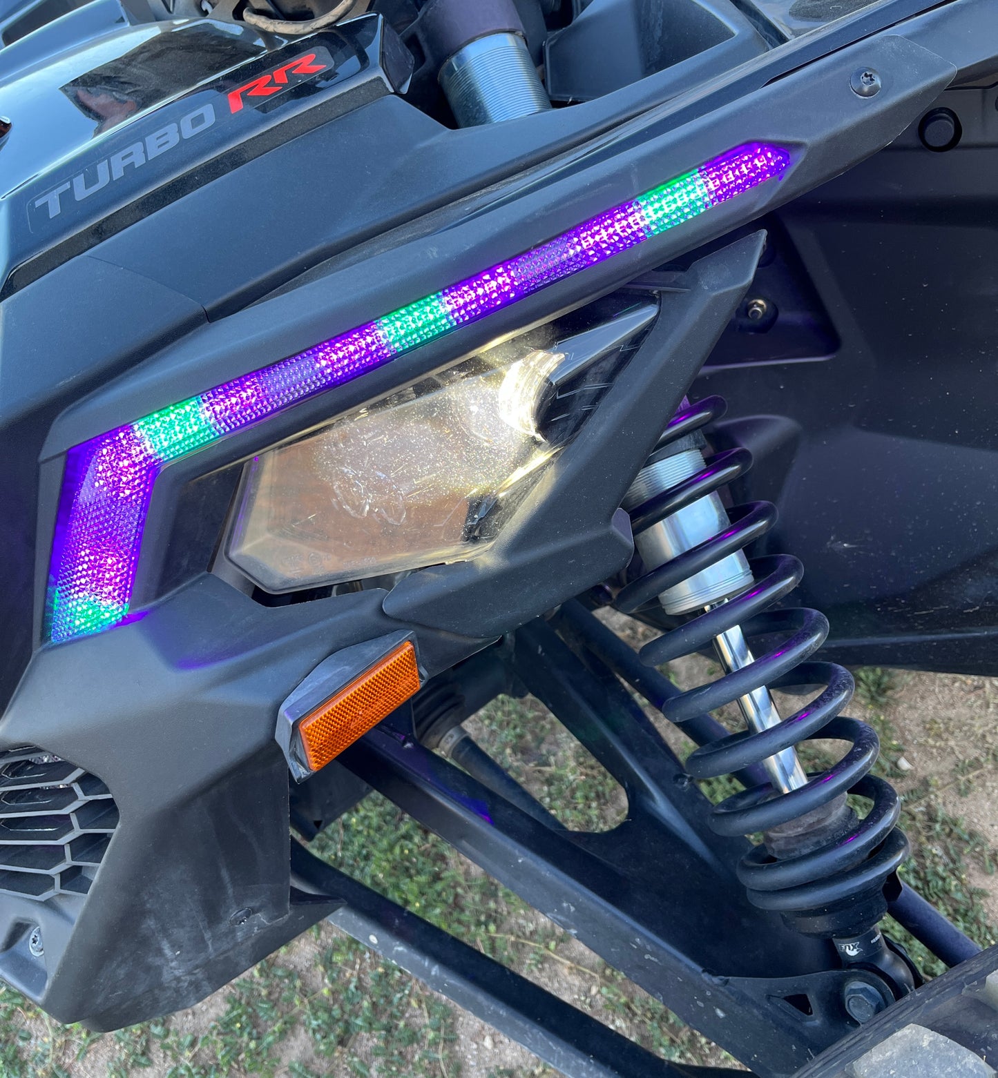 Can Am X3 RGBW Brow Lights installed on the vehicle, showcasing vibrant lighting for off-road performance and style.