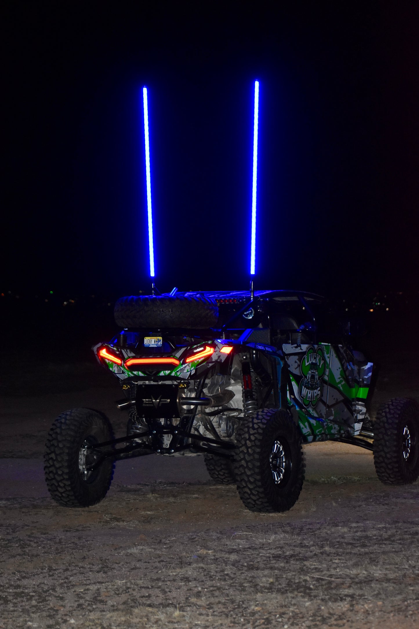 LED whips by My Store, 6ft tall, glowing brightly in vibrant colors against a dark background.